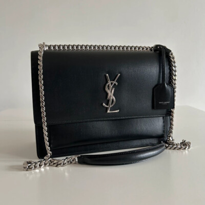YVES SAINT LAURENT sunset en cuir graine noir large bijouterie argentée. LUXE DE SECONDE MAIN AUTHENTIQUE. SAC YSL d'OCCASION PAS CHER. CERTIFICAT D'AUTHENTICITE ENTRUPY