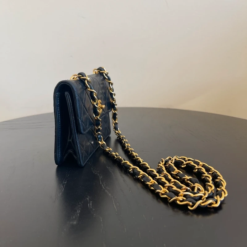 CHANEL mini flap bag en cuir d'agneau lisse noir & doré avec poinçon. SAC DE LUXE DE SECONDE MAIN AUTHENTIQUE CERTIFICAT D'AUTHENTICITE ENTRUPY. SAC DE LUXE D'OCCASION PAS CHER. Chanel timeless
