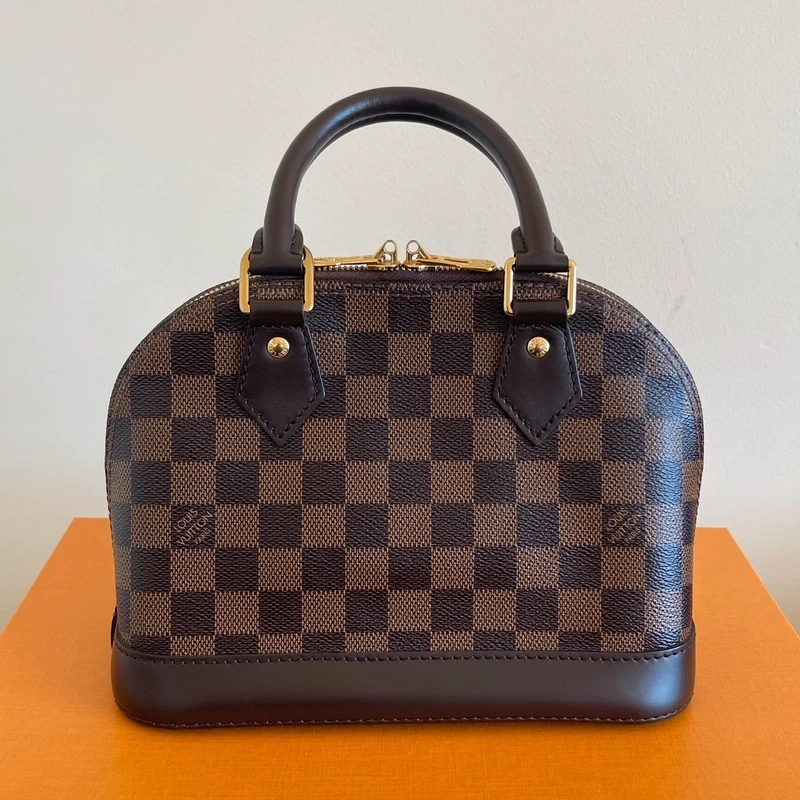 LOUIS VUITTON Alma BB damier ébène LUXE DE SECONDE MAIN AUTHENTIQUE CERTIFICAT D'AUTHENTICITE ENTRUPY. SAC DE LUXE D'OCCASION PAS CHER LOUIS VUITTON FULL SET.
